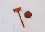 a top-down image of a gavel on a marble worktop