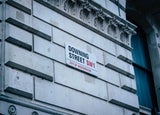 an outside shot of Downing Street, London, UK, showing its street sign