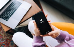 Woman holding iPhone with TikTok app logo on the screen. Rostov-