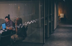 two men working in a dark office
