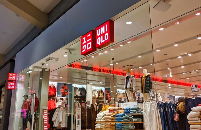 Bellevue, WA / USA - November 1st, 2019: Uniqlo clothing store in a mall, with lots of different fall and winter clothing on display and on sale.