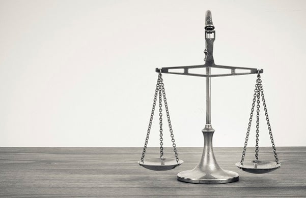 silver balancing scales on a desk