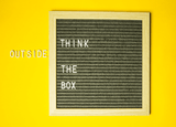 Black square board on a yellow background with the text 